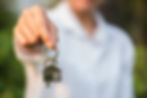 Man Holding House Key (This is meant to imply Rental Property Management on the Sunshine Coast)